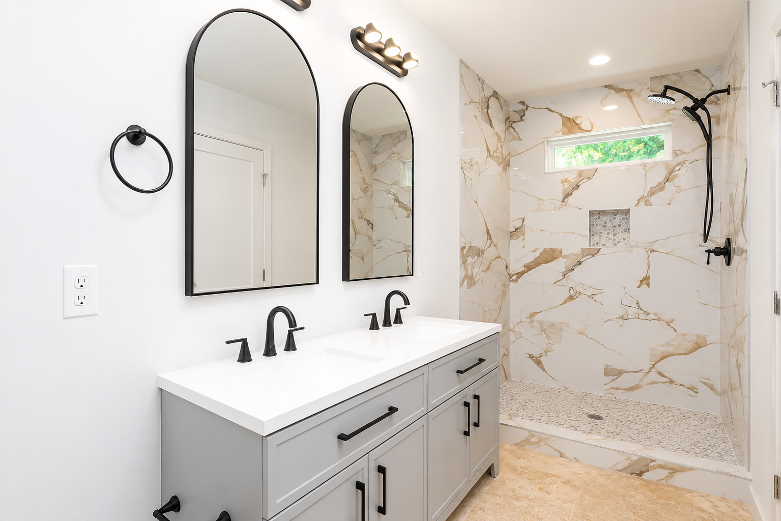 Modern bathroom with arched black mirrors, marble shower surround and gray double vanity
