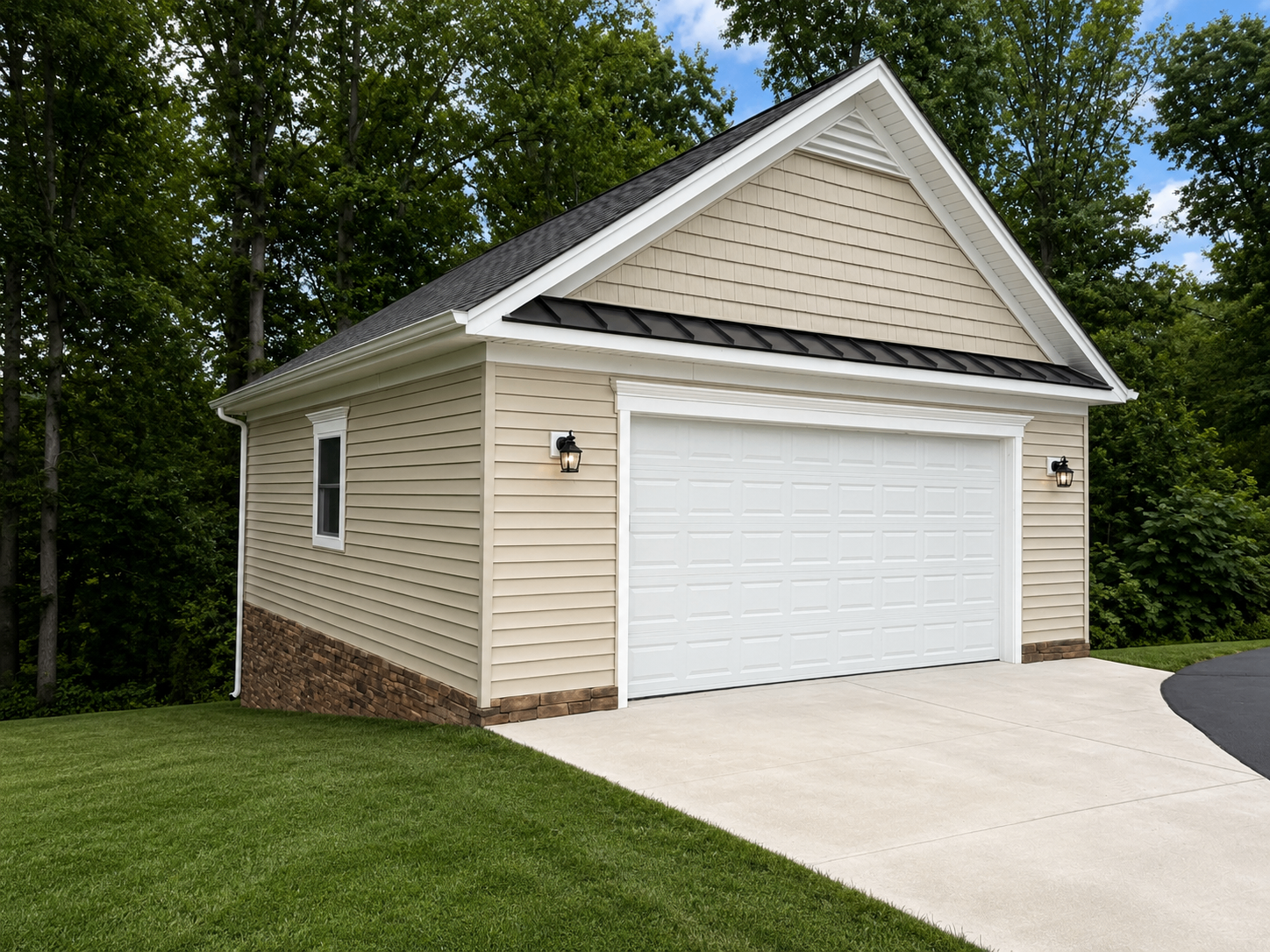Detached two-car garage with tan siding, stone skirt and white overhead door